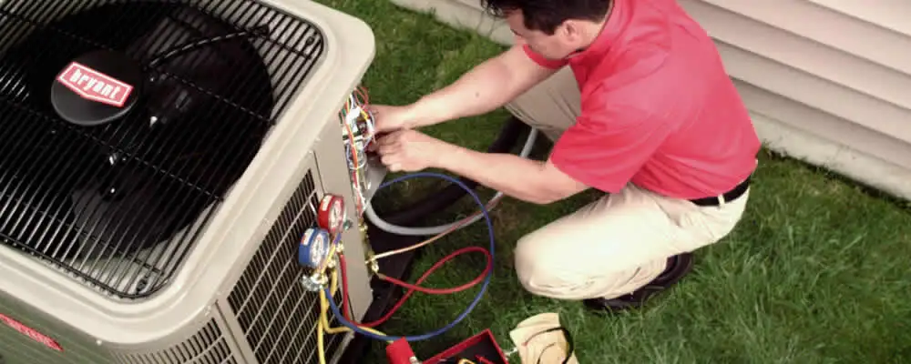 HVAC technician servicing an outdoor air conditioner unit in Chicago, IL
